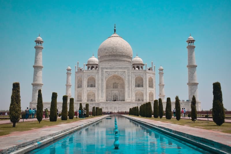 The Taj Mahal reflected in its iconic pool at sunrise